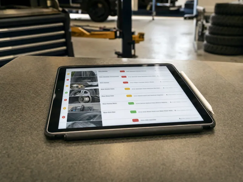 A tablet showing inspection photos and measurements